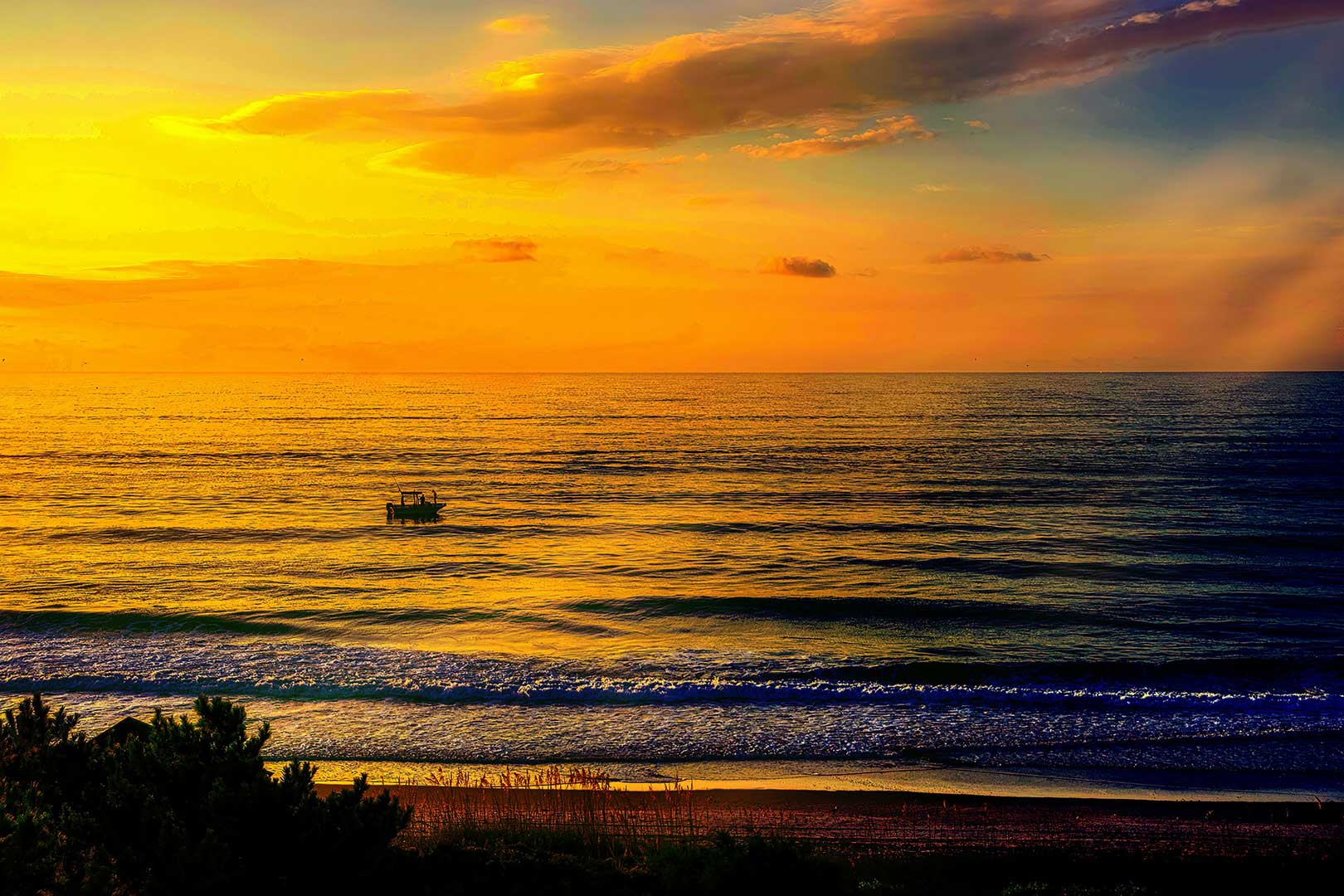 Golden sunset over calm ocean water